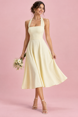 Pale yellow midi dress with a fit-and-flare skirt and square neck